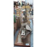 Plastic model of a ship on wooden base (possibly Cutty Sark) - distressed. (B.P. 24% incl.