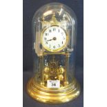 20th century brass frame, hundred day perpetual motion dome clock with enamel face and glass dome.