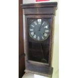 Early 20th century stained, two-train wall clock with black face and painted Roman numerals. (B.P.