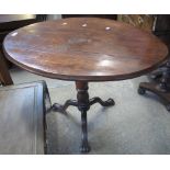 19th century mahogany tilt top tripod table of oval form on paw feet. (B.P. 24% incl.