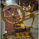 Modern beech spinning wheel with carved Welsh themed items to include daffodil, leek, dragon,