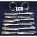 Set of six silver handled dessert knives, together with two napkin rings, one silver. (B.P.