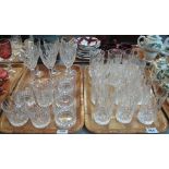 Two trays of cut and moulded glass drinking vessels, tumblers, whiskey tumblers, wine glasses etc.