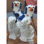 Pair of Staffordshire-type blue and white fire-side Spaniels together with two other similar seated