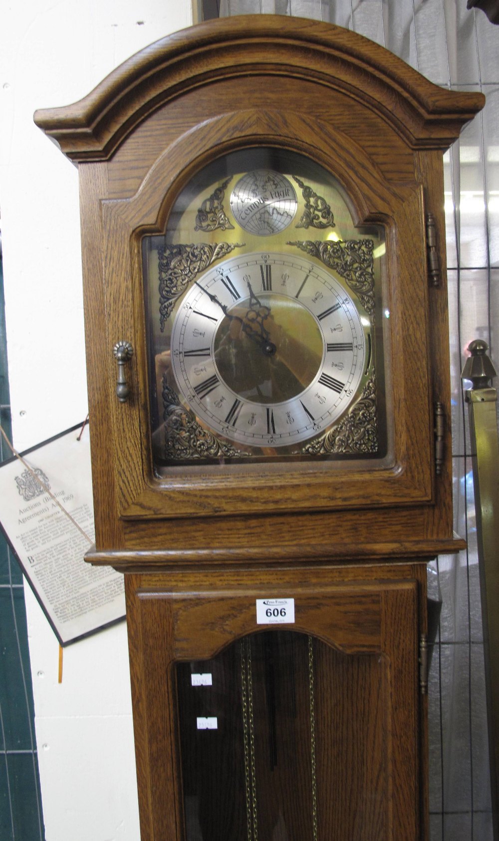 Modern oak long case clock having silver dial with Roman numerals and three weights. (B.P. 24% incl.