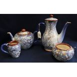 Doulton Lambeth four-piece tea service having blue, white and gilded stylized foliate decoration,