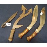 Group of edged weapons to include pair of Nepalese Kukri knives, lacking scabbards,