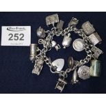 Heavy silver charm bracelet with charms. (B.P. 24% incl.