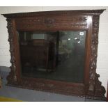 Early 20th century heavily carved oak, over mantle mirror with lion mask mounts. (B.P. 24% incl.