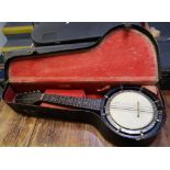 Eight-string banjo bodied mandolin with tuning fork, in canvas covered case.