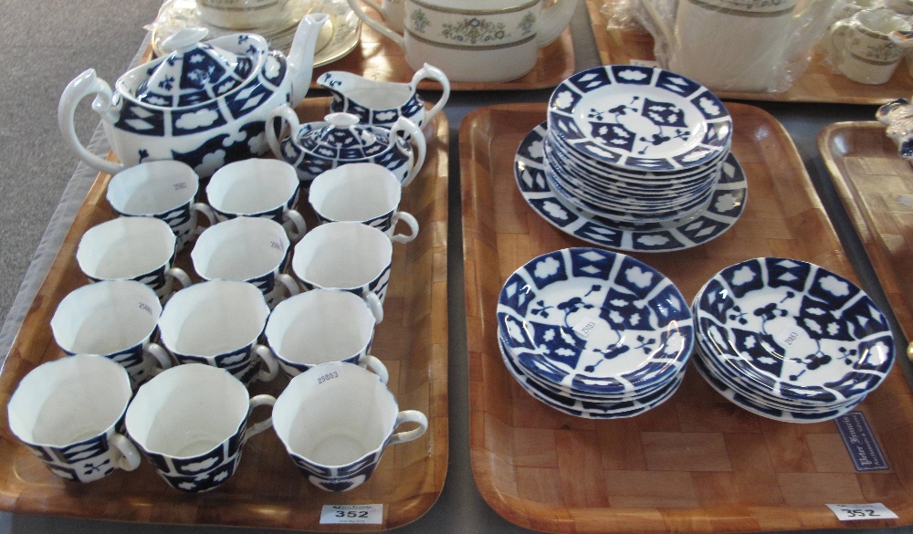 Two trays of 19th century teaware on a blue and white geometric and foliate ground. (2) (B.P.