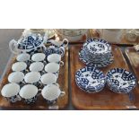 Two trays of 19th century teaware on a blue and white geometric and foliate ground. (2) (B.P.