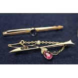 9ct gold sapphire bar brooch and a 15ct gold bar brooch set with a pink stone . (B.P. 24% incl.