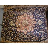 Modern Persian style Keshan design carpet on a blue ground with floral and foliate decoration.