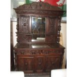 Late 19th/early 20th Century heavily carved oak mirror back sideboard with carved flower heads and