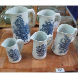 Set of five Royal Worcester graduated blue and white floral and foliate jugs with simulated bamboo