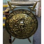 Repousse brass circular shield with two swords. (B.P. 24% incl.