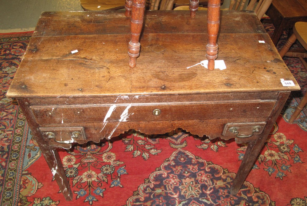 Early 19th Century oak lowboy on square tapering legs. No estimate, no reserve. Water damaged. (B.P.
