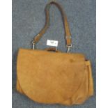 A brown leather mailbag/messenger bag by 'The J. Peterman Company, Lexington, Kentucky'. (B.P.