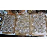 Three trays of matching drinking vessels and trifle bowls,