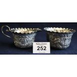 Repousse silver cream jug with crimped edge and loop handle, together with matching sucrier.