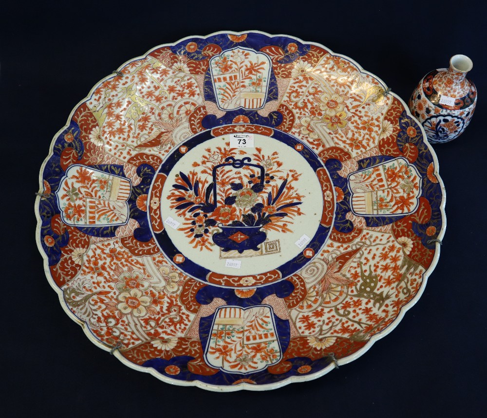 Large Japanese porcelain Arita Imari design charger having indented rim and being decorated with