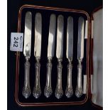 Set of six silver handled repousse decorated dessert knives in leather case. (B.P. 24% incl.