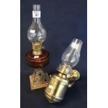 Early 20th Century brass single burner oil lamp with glass reservoir on cast metal base having