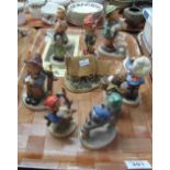 Nine Hummel figurines, together with a Rose Cottage by David Winter. (B.P. 24% incl.