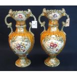 Pair of Austrian pottery baluster shaped two handled vases with painted decoration.