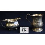 Small silver baluster shaped christening mug and a half lobed silver cream jug.