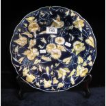 Meissen porcelain dish with gilded relief convolvulus foliate decoration on a dark blue ground.