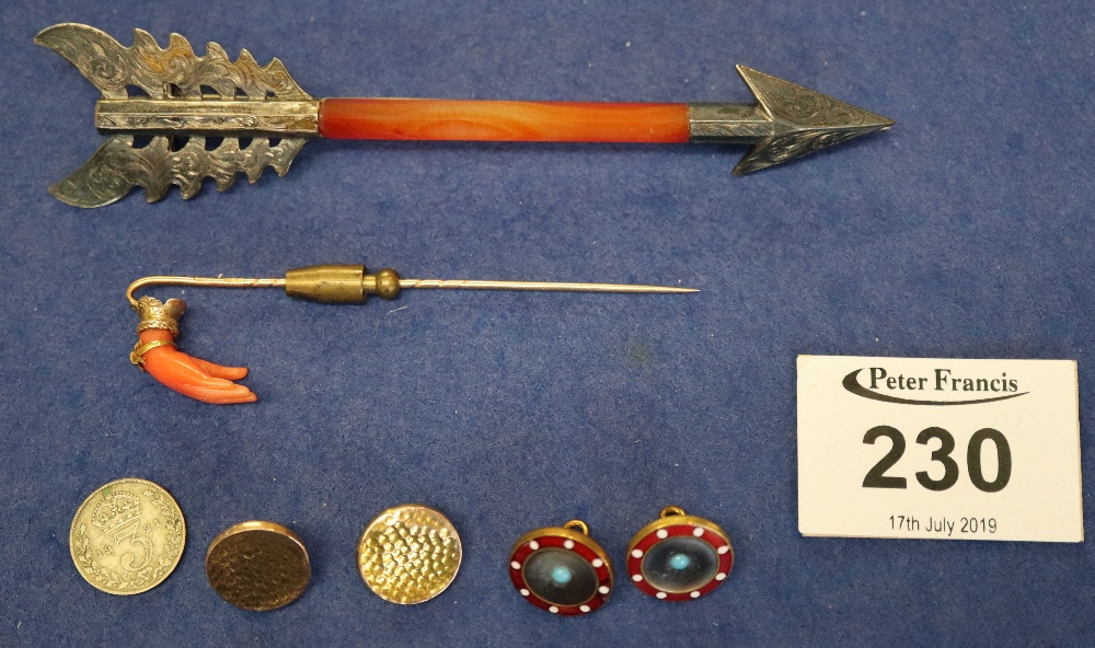 A carnelian long bar brooch shaped as an arrow, two buttons, a coral hand stick pin etc. (B.P.