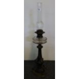 Late 19th Century brass double burner oil lamp with clear cut glass reservoir on a yellow metal and