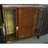 Early 20th Century mahogany break front display cabinet on cabriole legs and ball and claw feet.