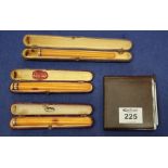 Three amber cigarette holders and a bakelite cigarette case. (B.P. 24% incl.