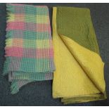 A vintage double size quilt with green on one side and yellow on the other,