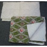 A small cream quilted table mat or throw and a green ground double size floral design quilt with