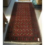 Middle Eastern Bokhara design red ground geometric rug. (B.P. 24% incl.