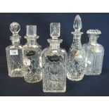 Group of five assorted cut lead crystal spirit decanters of differing forms with stoppers,