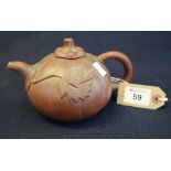Chinese Yixing teapot of melon shape with loop handle and relief leaf decoration.