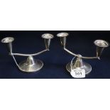 Pair of silver Art Deco design two branch miniature candelabra with domed circular loaded bases.