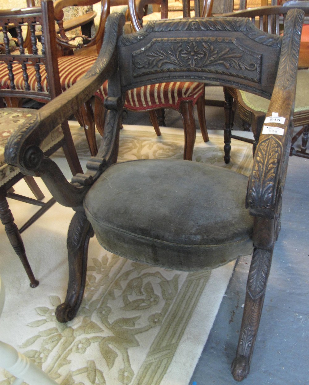 19th Century carved oak folding savonarola style chair having foliate moulded panels,