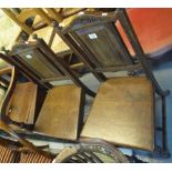 Pair of oak Edwardian hall chairs with rectangular fielded panels to the back on turned legs.