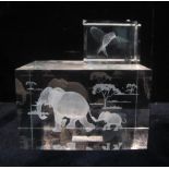 Two rectangular glass desk or paperweights inset with elephants and a hummingbird. (2) (B.P.