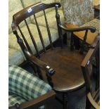 Early 20th Century stained spindle back kitchen armchair on circular moulded seat. (B.P. 24% incl.