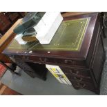 Reproduction mahogany knee hole desk having three drawers to each pedestal with leather inset top.