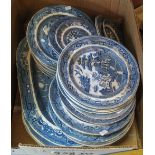 Box of assorted blue and white willow design plates and oval meat dishes. (B.P. 24% incl.