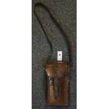 Heavy leather rectangular shaped carrying case with shoulder strap and other fittings,