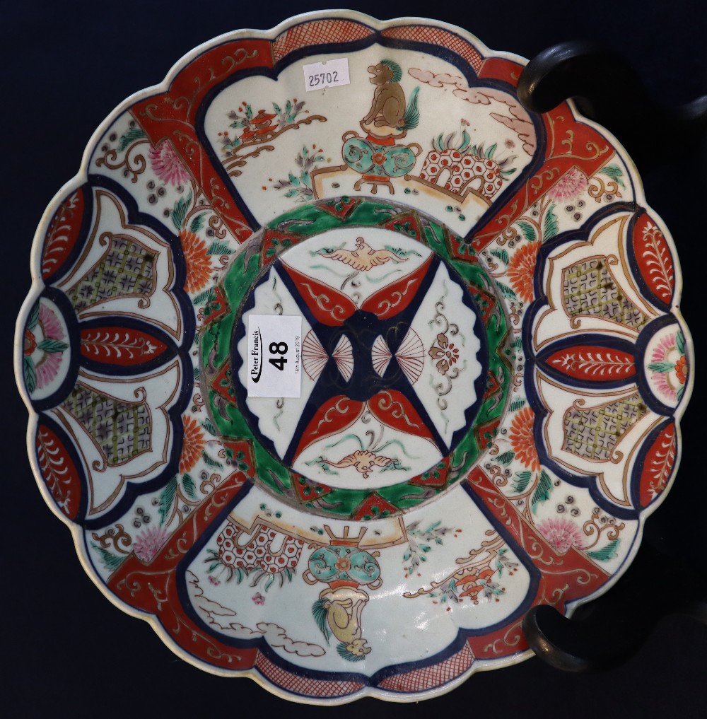 Japanese Imari porcelain petal rimmed charger with reserved decorative panels depicting stylised